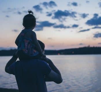 man carries girl